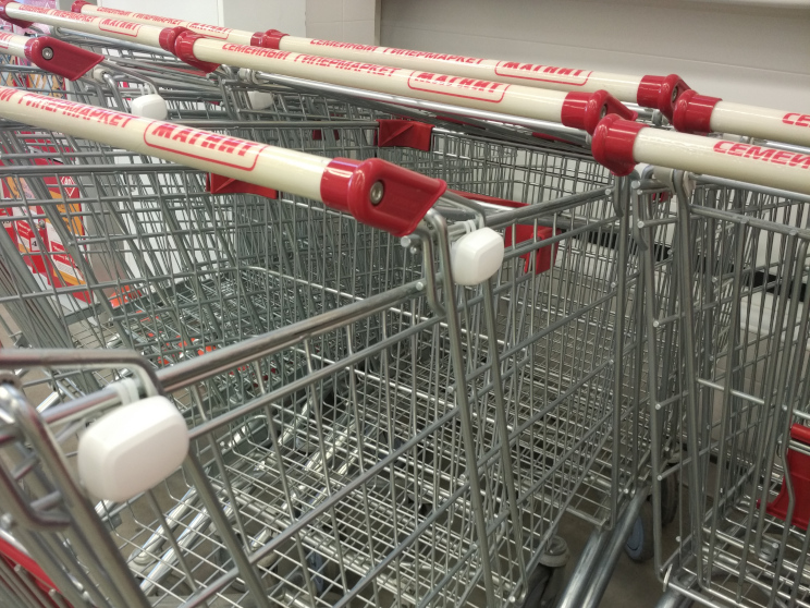 Tokens attached to stacked shopping carts in a supermarket - via Shoppermotion