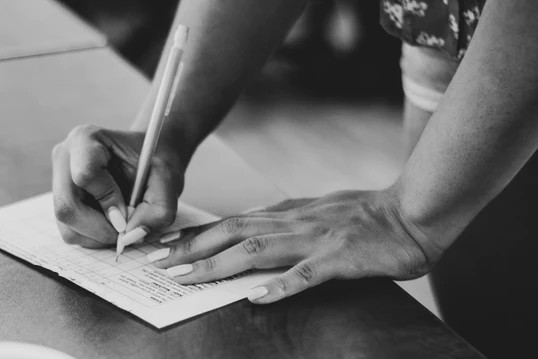 Woman taking notes about a customer journey in a grocery store